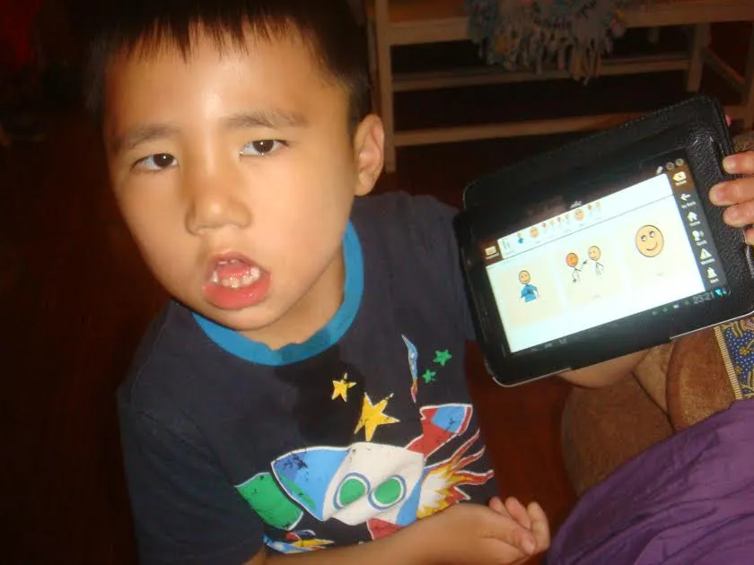 Theo holding a tablet with Avaz